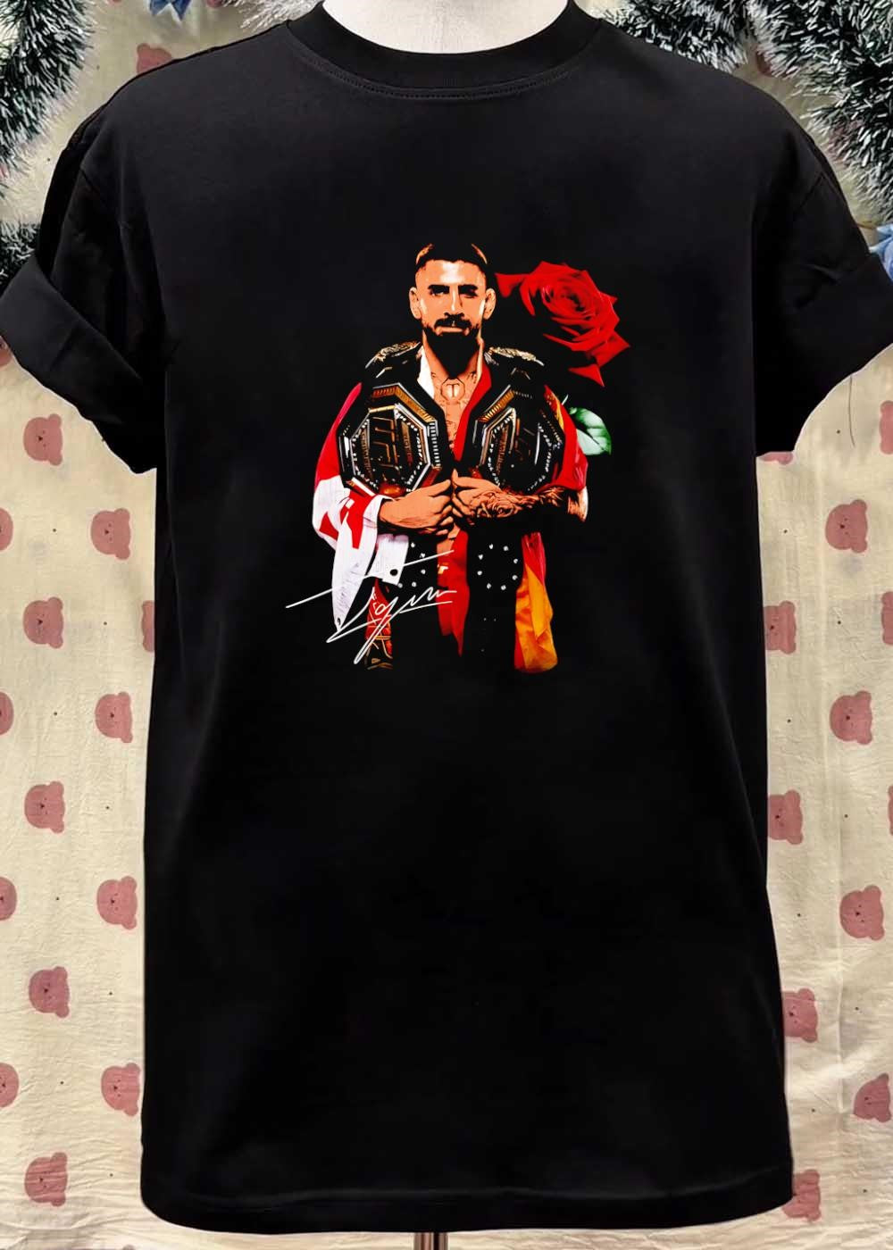 Ilia Topuria Holding UFC Championship Belts With Rose Shirt